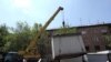 Armenia - Municipal workers dismantle a kiosk in Yerevan, 10Aug2011.