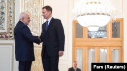 Iranian Foreign Minister Mohammad Javad Zarif (left) shakes hands with British Foreign Secretary Jeremy Hunt, in Tehran, November 19, 2018