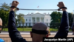 A Uyghur activist rallies in front of the White House. (file photo)