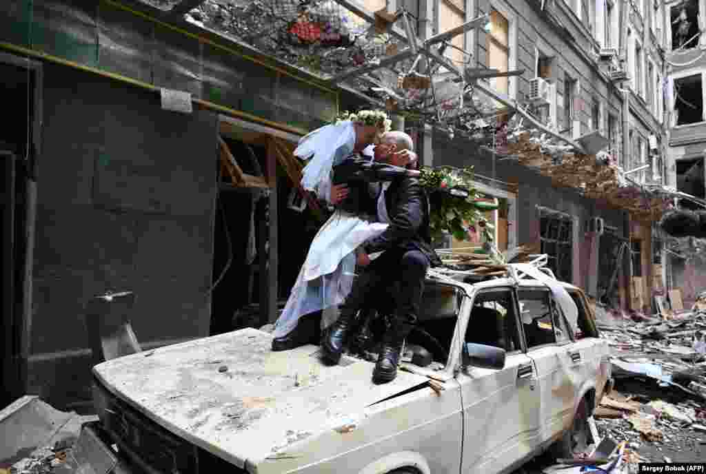 Nastya Gracheva and Anton Sokolov pose for their wedding photos in a damaged courtyard of Kharkiv on April 3. The nurse and doctor together provided free medical care and raised money for medicines needed by people in their city.