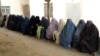 Afghan women prisoners listen to female prison officers at a prison in Kandahar.