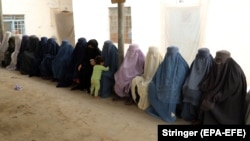 Afghan women prisoners listen to female prison officers at a prison in Kandahar.