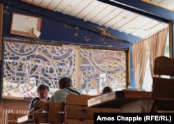 Shrapnel damage is seen in a cafe that recently reopened near Irpin.