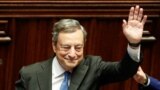 Italy's Prime Minister Mario Draghi waves as he leaves after addressing the lower house of parliament