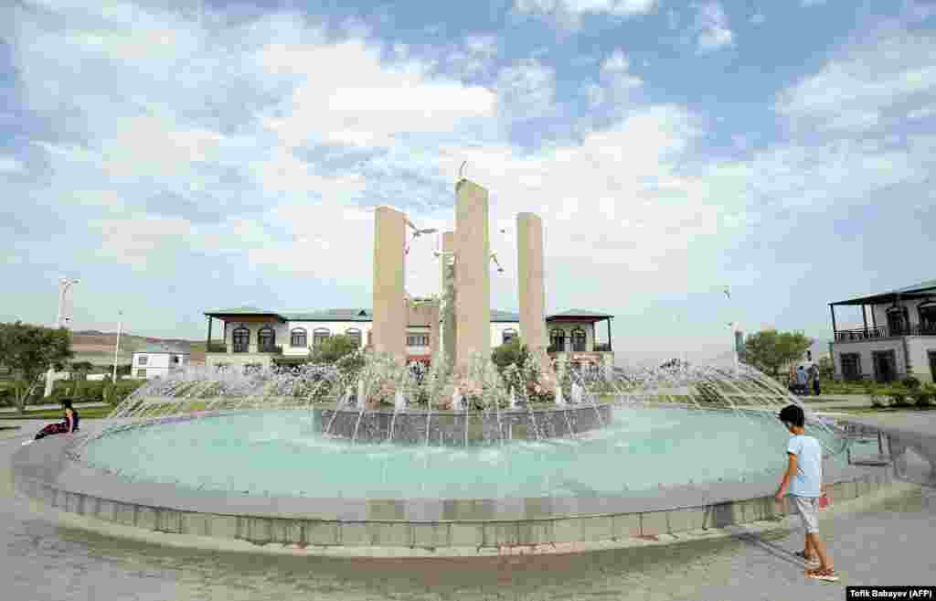 A fountain intended to symbolize peace in the center of Agali. Critics of the flashy new village say the settlement, located in an isolated region of Azerbaijan will have little to offer in terms of work. &nbsp;