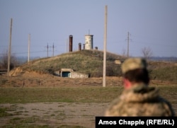 A Ukrainian soldier stands near an entrance to the Pervomaysk missile base in April 2019.