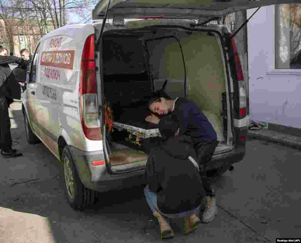 Oksana Kolesnikova embraces the coffin of her son, Anatoliy Kolesnikov, in Irpin, a town near Kyiv, on April 15. Thirty-year-old Anatoliy was a territorial defense soldier killed during the opening phase of the invasion of Ukraine.&nbsp;