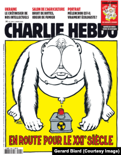 A Charlie Hebdo front cover depicting Putin astride a nuclear button.