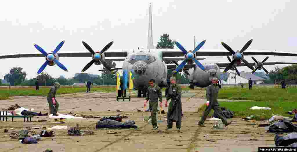 Rescue workers remove the bodies of those killed.