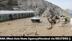 Rescuers work following the flood in Imamzadeh Davoud village to the north of Tehran on July 28.