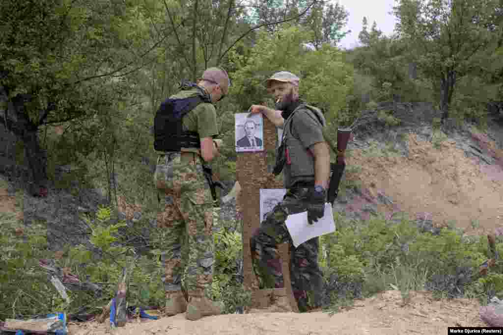 Members of the Carpathian Sich Battalion practice shooting with targets depicting Russian President Vladimir Putin during training in the Kharkiv region. The battalion is one of several paramilitary groups formed by Ukraine&#39;s Svoboda party that began with volunteers in 2014 after Moscow seized Crimea and supported pro-Russia separatists in the country&#39;s eastern Donbas region. The Svoboda party is an ultranationalist political party led by Oleh Tyahnybok.