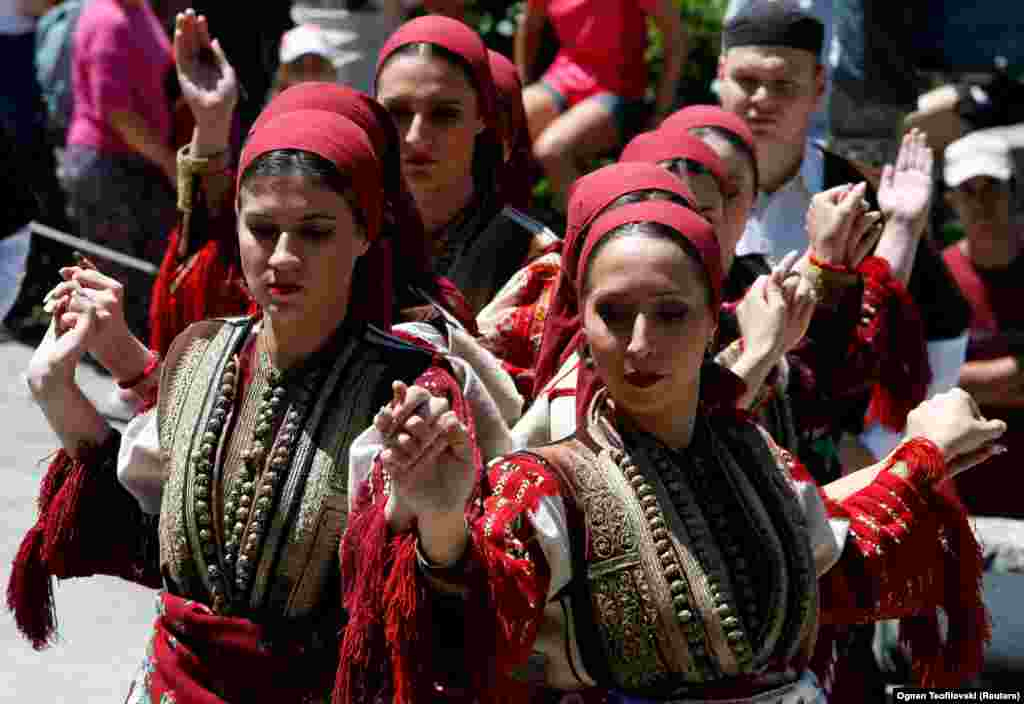 Women dance in traditional folk costumes.