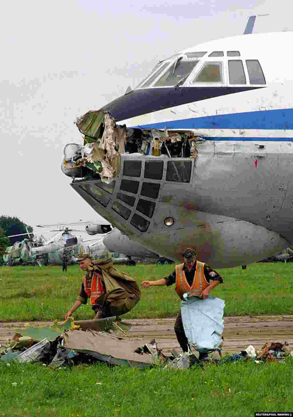 Rescue workers clear bodies and debris in front of the Ilyushin Il-76 transport aircraft that was struck by the left wing of the Su-27. The pilots stated that the flight map they had received differed from the actual layout of the airfield.