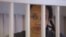 U.S. basketball player Brittney Griner stands inside a defendants' cage during the reading of the court's verdict in Khimki outside Moscow in August.