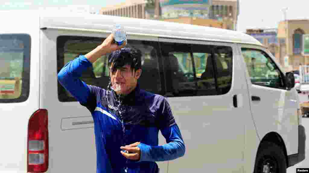 A hőhullám nem csak Európát sújtja: ezen a képen egy férfi egy üveg vizet önt a fejére az utcán, hogy hűtse magát az iraki Bagdadban 2022. július 19-én