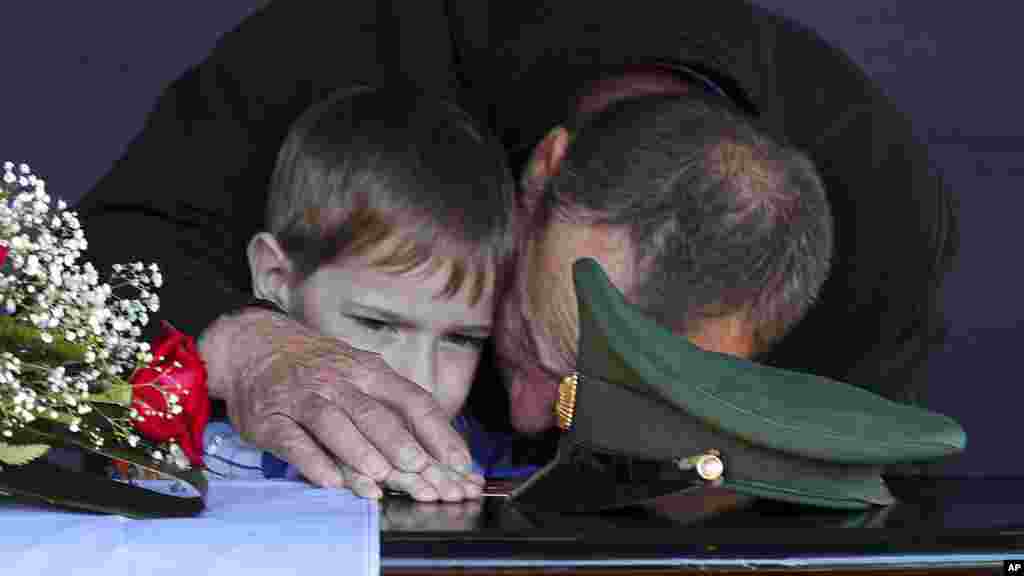 Otac i sin narednika ruske vojske Danila Dumenka, koji je ubijen tokom borbi u Ukrajini, plaču na njegovoj sahrani, Volžski blizu Volgograda u Rusiji, 26. maja.