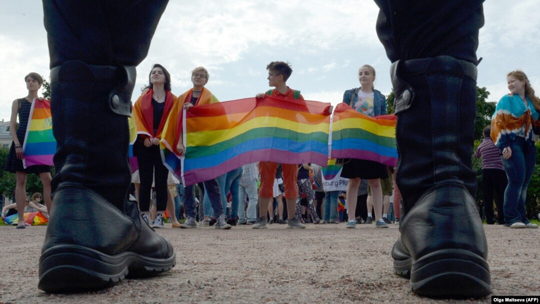 People wave rainbow flags during a gay-pride rally in St. Petersburg in 2017.