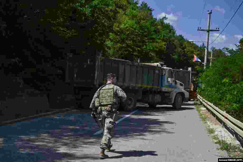 Një ushtar amerikan i NATO-s duke ecur nëpër një rrugë të bllokuar nga serbët lokalë.