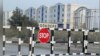 Turkmenistan. Gokdepe - "stop" road sign. White buildings. July 2022