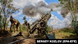 Ukrainian soldiers operate a U.S.-made 155mm M777 howitzer at their position in the Kharkiv area of Ukraine on July 28.