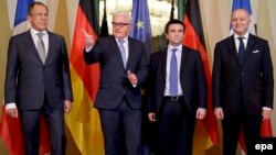 German Foreign Minister Frank-Walter Steinmeier gestures as he is flanked by Russian Foreign Minister Sergei Lavrov (far left), French Foreign Minister Laurent Fabius (right), and Ukrainian Foreign Minister Pavlo Klimkin (second from right) at the start of talks in Berlin on January 12.