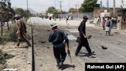 Afghan police arrive at the site of a suicide car bomb in Kabul last month.