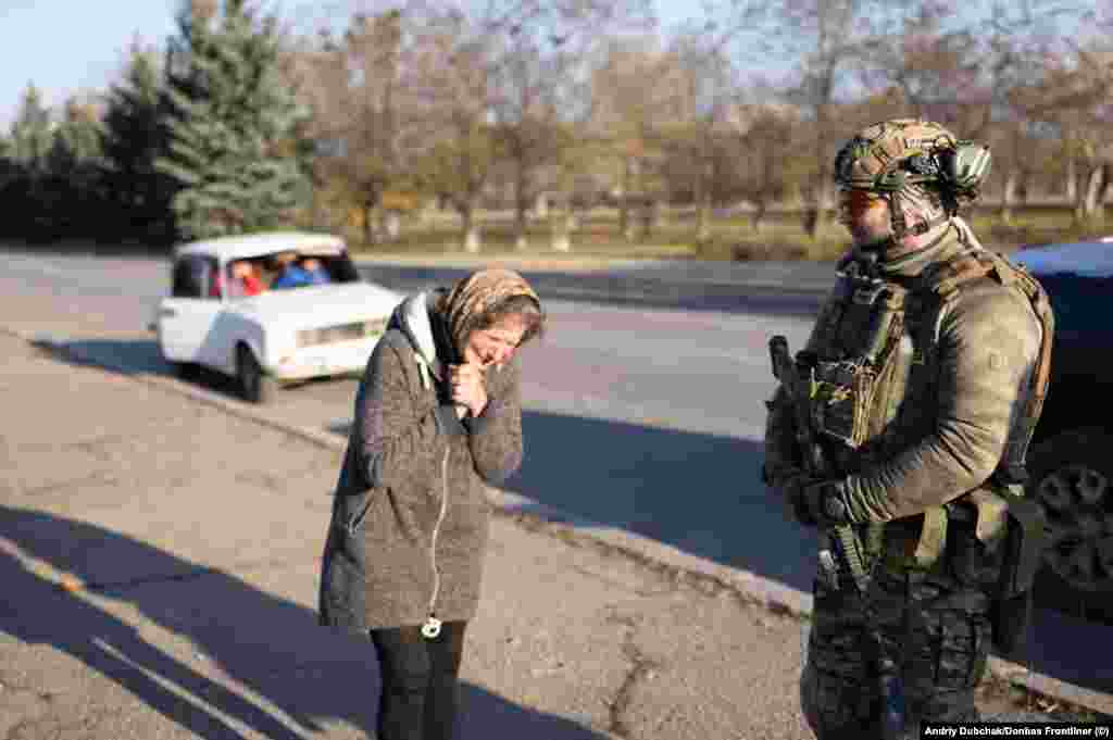 A woman weeps, moments before stepping forward and blessing a Ukrainian soldier.&nbsp; This and other photos in this gallery show the scenes in Snihurivka on the evening of November 10 as advance forces of the Ukrainian military recaptured the town in the southern Mykolayiv region.