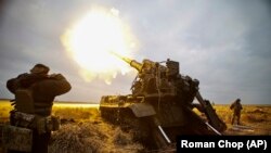 A self-propelled artillery vehicle fires near Bakhmut, Donetsk region, Ukraine, on November 10.