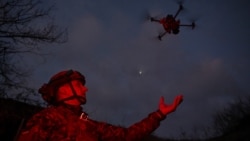 A member of the Сonsolidated Brigade Khyzhak (Predator) of the Ukrainian Patrol Police Department launches a drone at a position in a front line near the town of Toretsk, Donetsk region, Ukraine, on December 19.