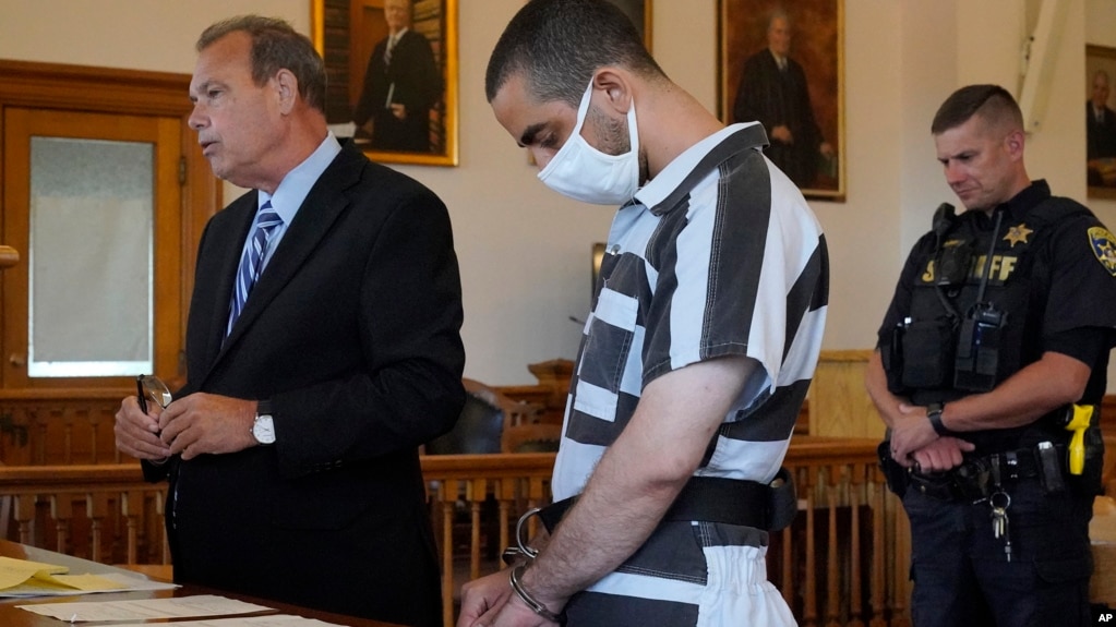 Hadi Matar, 24 (center), listens to his public defense attorney, Nathaniel Barone (left), address the judge while being arraigned in the Chautauqua County Courthouse in Mayville, New York, on August 13.