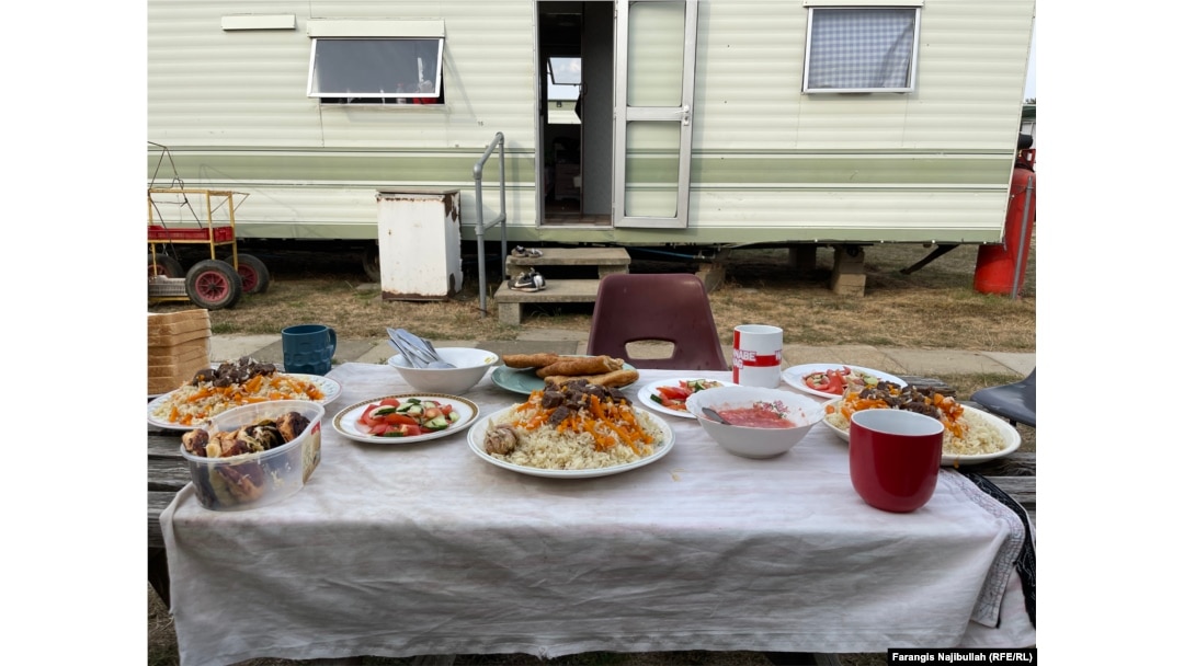 Uzbek seasonal workers in Britain prepare lunch with their traditional dish, plov.