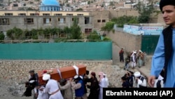 Mourners carry the body of a victim of the mosque bombing in Kabul on August 18.