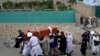 Mourners carry the body of a victim of a mosque bombing in Kabul that killed Hanafi cleric Amir Mohammad Kabuli and 20 more worshippers on August 17.