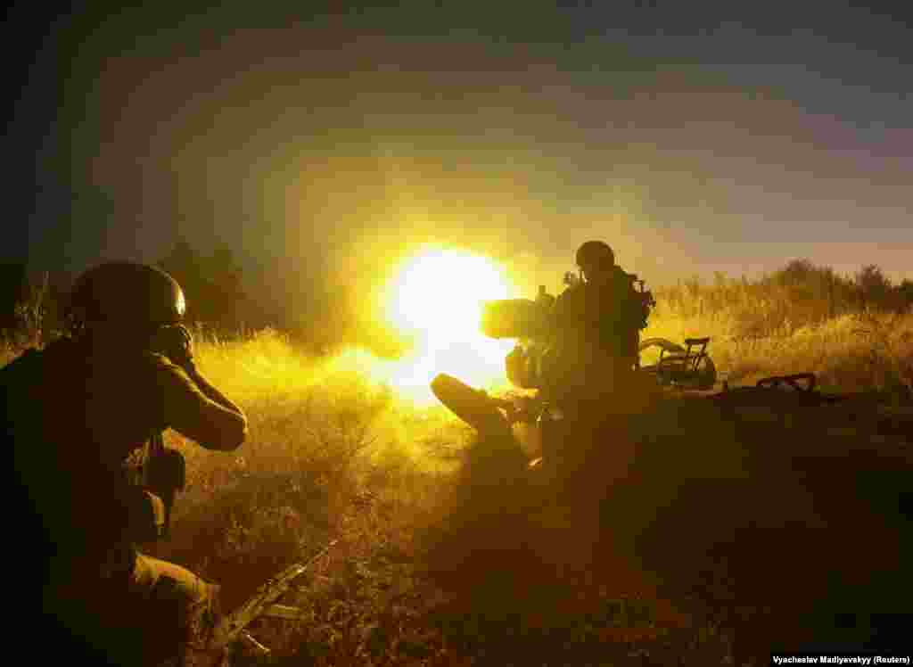 A Ukrainian soldier fires with a ZU-23-2 anti-aircraft cannon at a position near a front line in the Kharkiv region on August 24.