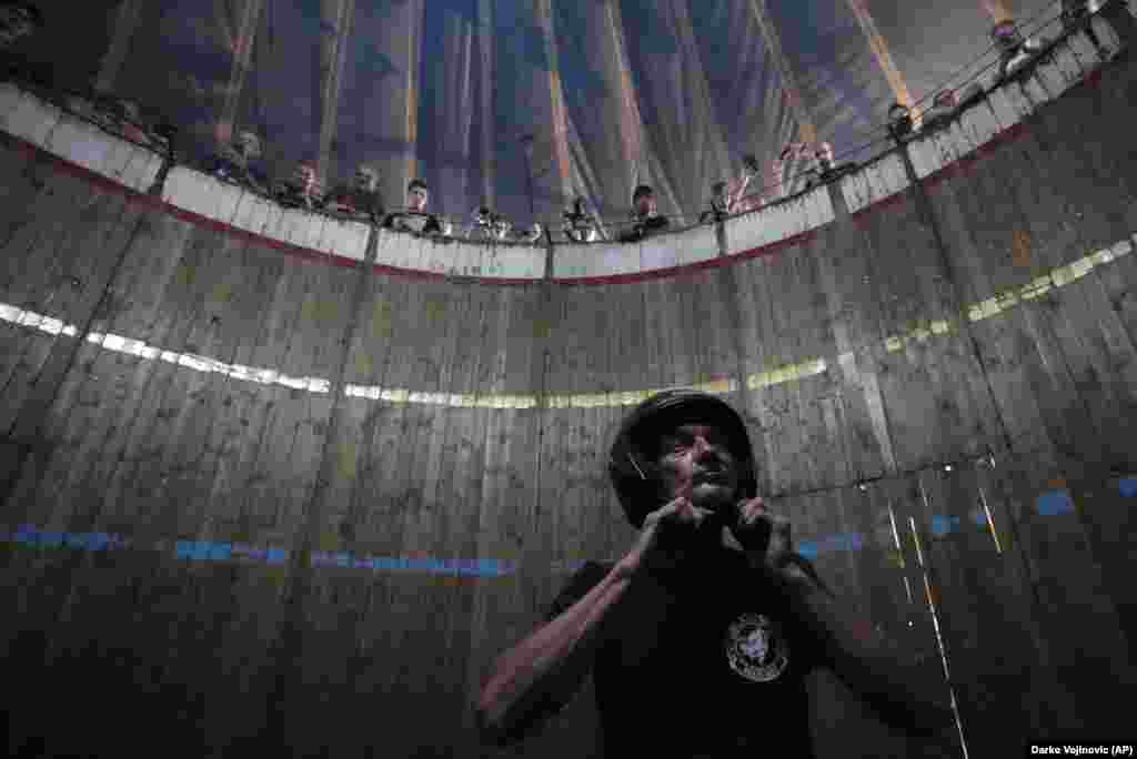 As the audience looks on, Milojkovic gets ready to perform his stunt in the &quot;Wall of Death.&quot;