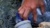 VIDEO GRAB: Kosovo citizen filling a bottle with water