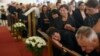 People react next to photographs of the dead during a commemoration ceremony in honor of the victims in Cetinje on August 14.