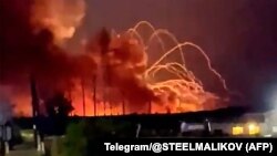 Fire and smoke billow from a munitions depot near the village of Timonovo outside Belgorod on August 18.