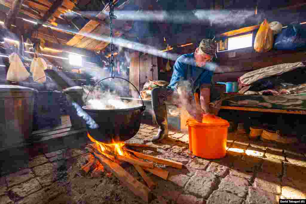 In the summer hut, the Bzhalava brothers begin a complex process of warming, mixing, and cooling older batches of milk.