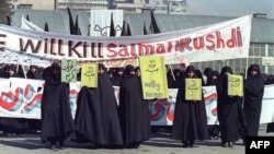 Iranian women are seen holding banners that read "Holly Koran" and "Kill Salman Rushdie" during a demonstration in Tehran on February 17, 1989.