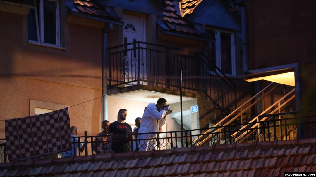 Emergency service personnel, police, and investigators work at the scene of the shooting in Cetinje on August 12.