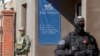 Russian police officers stand guard outside the office of Roizman Charity Fund on August 24 after its founder and politician Yevgeny Roizman was detained in Yekaterinburg.