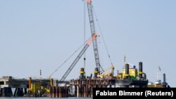 A planned floating liquefied natural gas terminal is shown under construction off the coast of Germany.