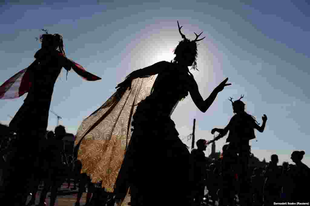 Artists perform as people gather to protest against the loosening of logging rules by Prime Minister Viktor Orban&#39;s government to meet increased demand for firewood amid a surge in gas and electricity prices, in Budapest.