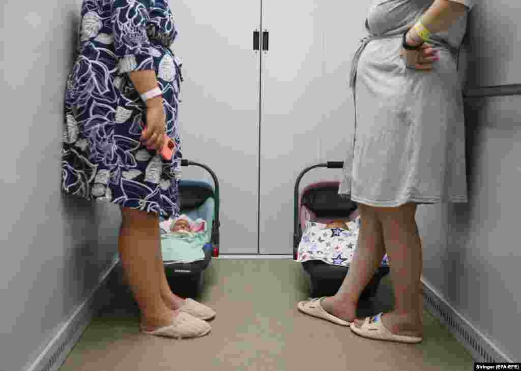 Mothers with their newborns ride an elevator down to a bomb shelter organized below a children&#39;s hospital during an air-raid alarm in Odesa, Ukraine. The underground shelter provides all necessary services for pregnant women, young mothers, and their babies.