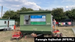 An Uzbek flag hanging at a caravan window in Britain. Most migrant workers live in caravans, shared by up to six people. 