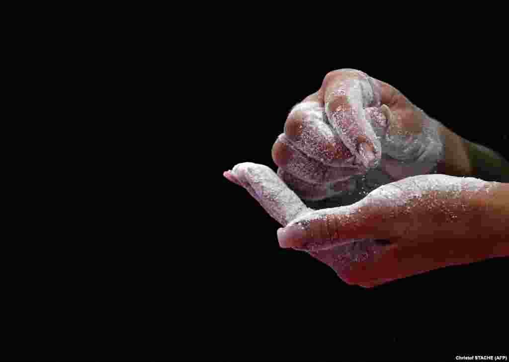 Hungarian athlete Zsofia Kovacs rubs her hands with chalk powder before she starts the women&#39;s floor exercise final at the European Artistic Gymnastics Championships in Munich, Germany.