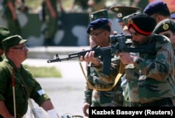 An Indian army officer aims a Russian assault rifle while visiting a range outside the Russian city of Vladikavkaz in 2010.