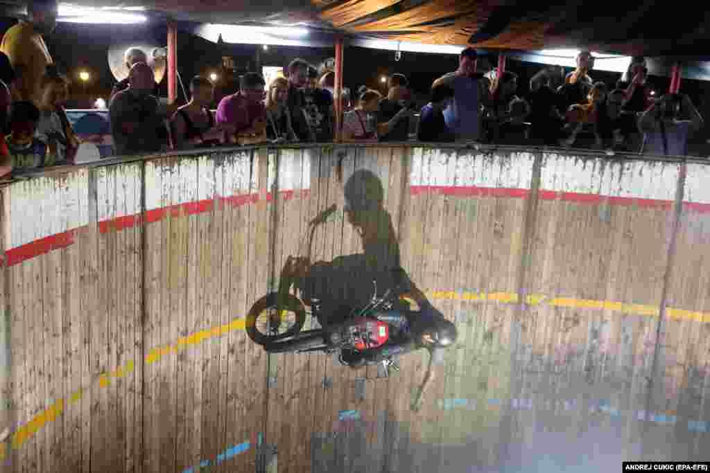 Spectators watch from above as Zoran Milojkovic rides the Wall of Death in Belgrade. The stunt rider, who is from the northwestern Bosnian town of Banja Luka, is believed to be the last of his kind on the Balkan peninsula.
