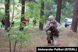 A member of the Spas-23 Battalion takes aim during an outdoor training session near Kyiv.